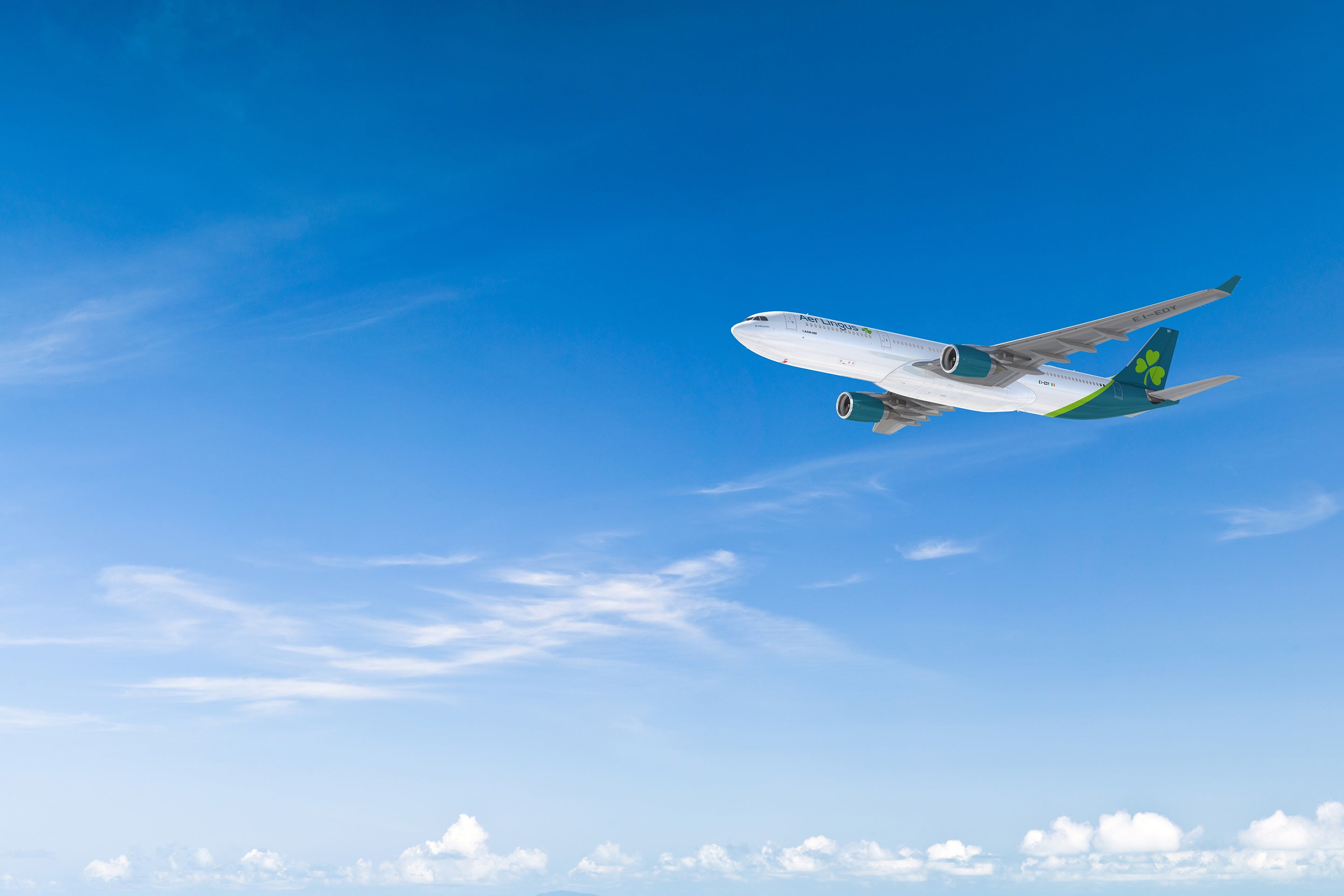 Aer Lingus A330 aircraft in flight against a clear blue sky