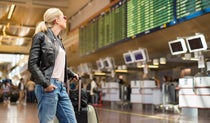 Woman looking at airport information board