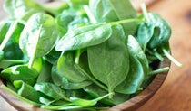 Spinach leaves in a wooden bowl
