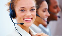 Smiling female call center agent wearing a headset