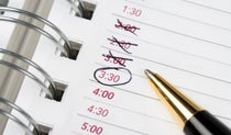 Close up of calendar book with a pen and times circled