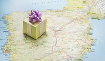A gift wrapped box sitting on top of a map of Spain