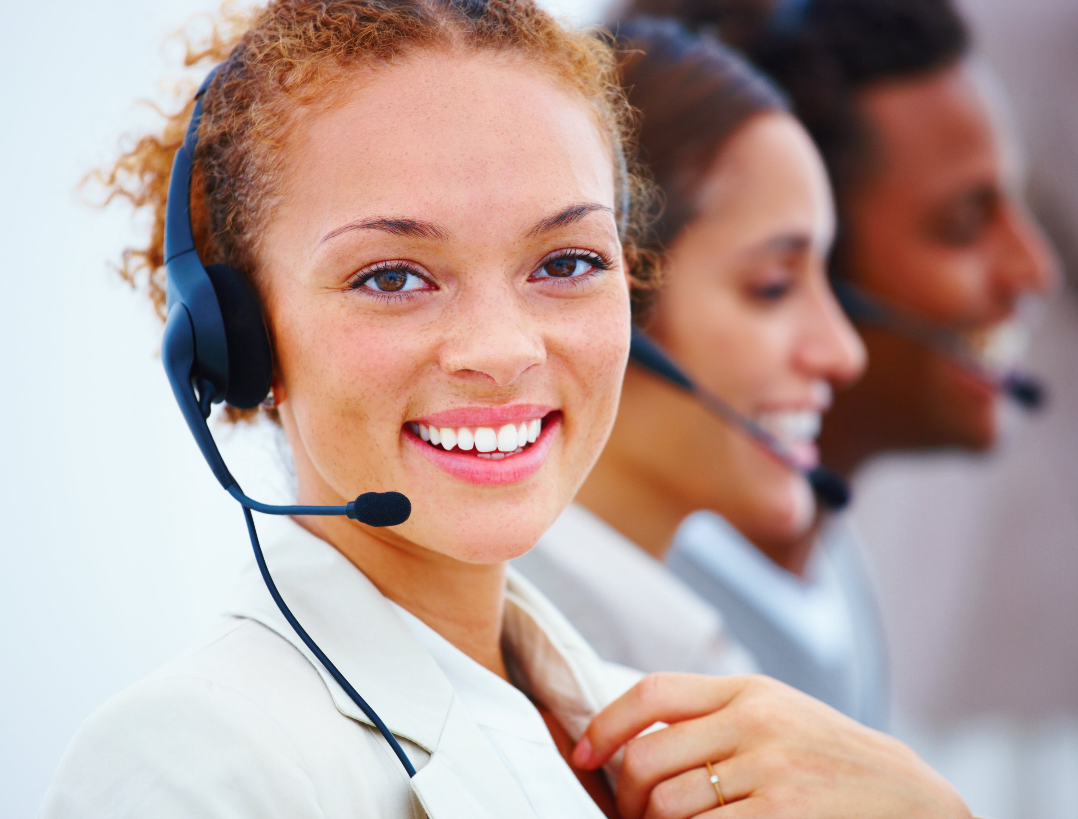 Smiling female call center agent wearing a headset
