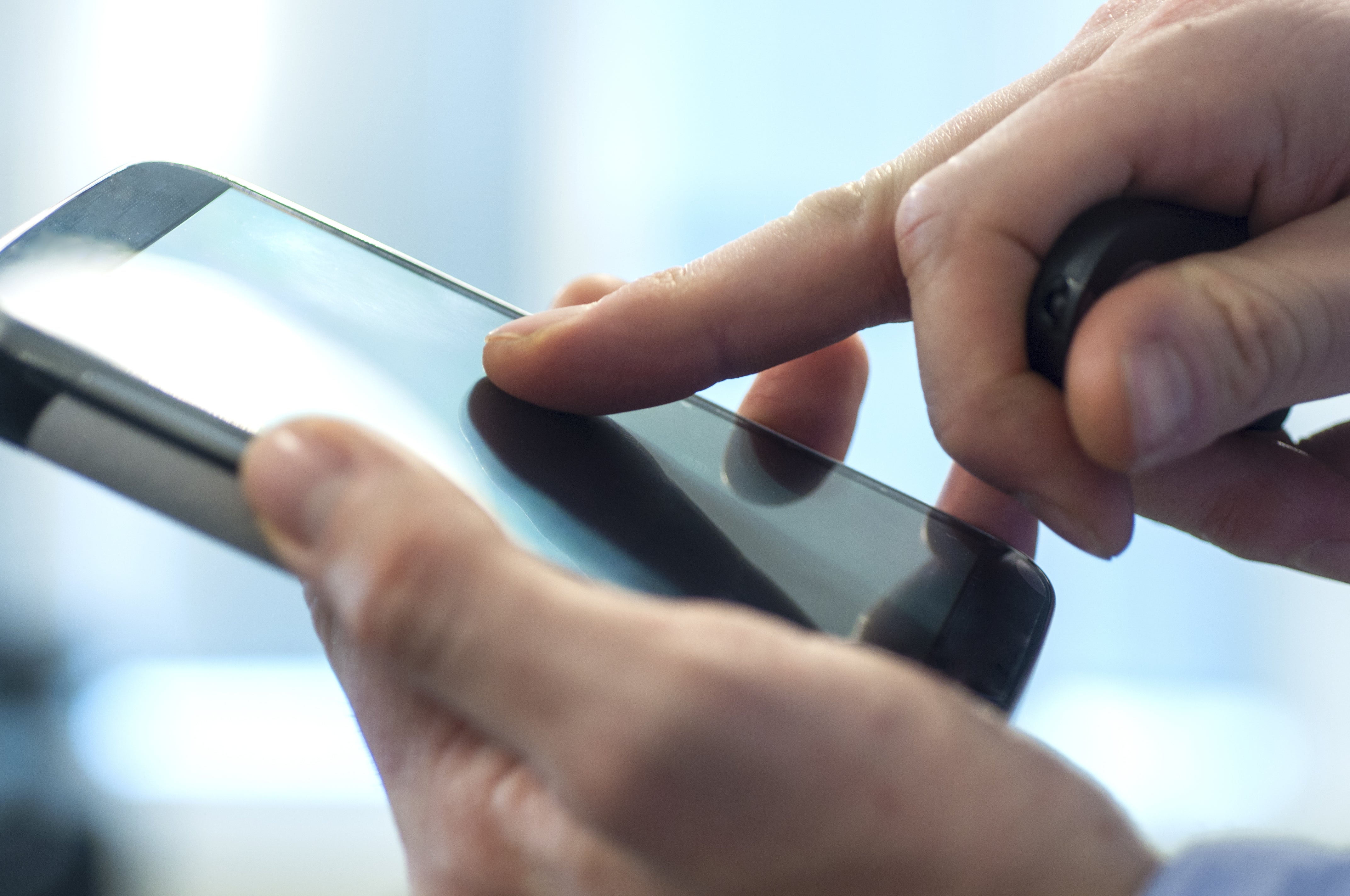Close up of person using a mobile phone screen